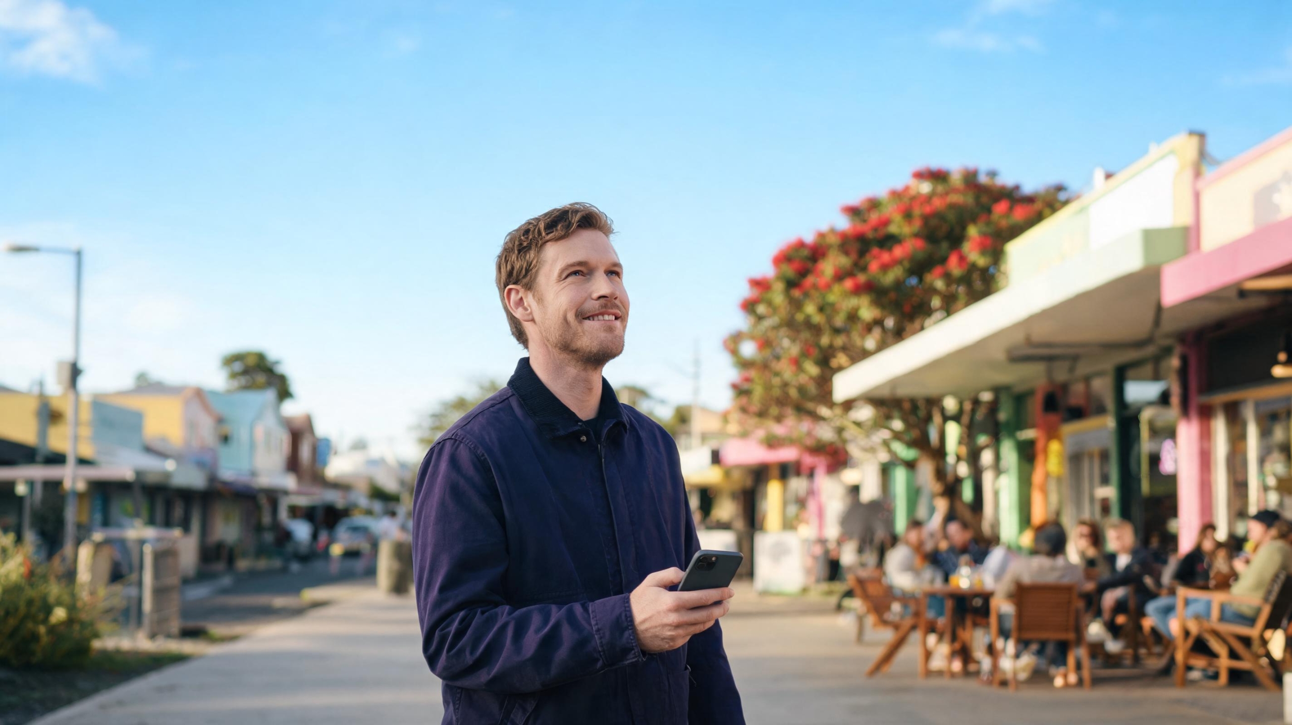 Customer on a sunny Auckland main street finding the local shop he searched for, the result of good local seo nz